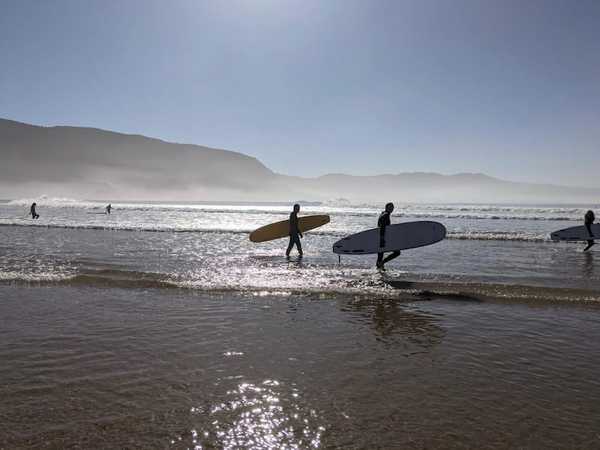 About to catch great waves with friends from SunDesk in Imsouane Beach, Morocco