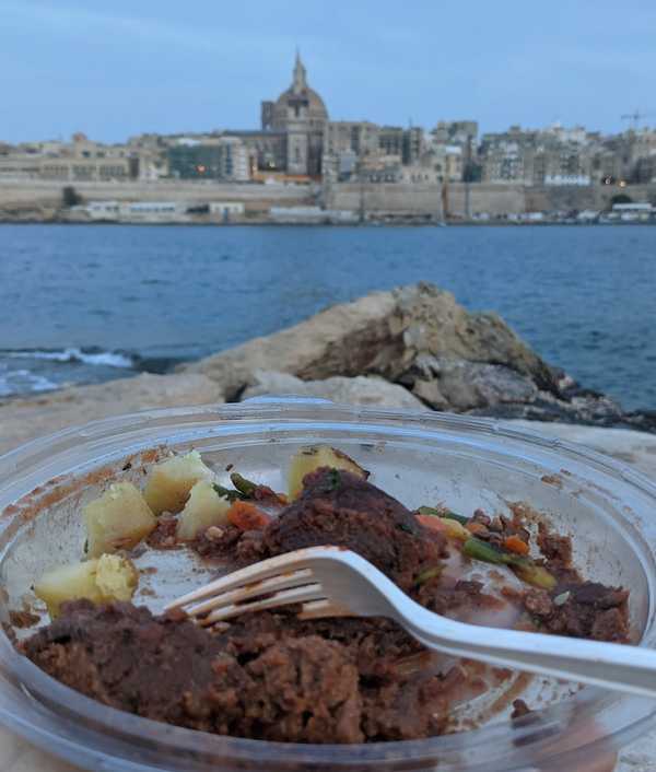 Enjoying maltese bragioli with views to Valletta, Malta